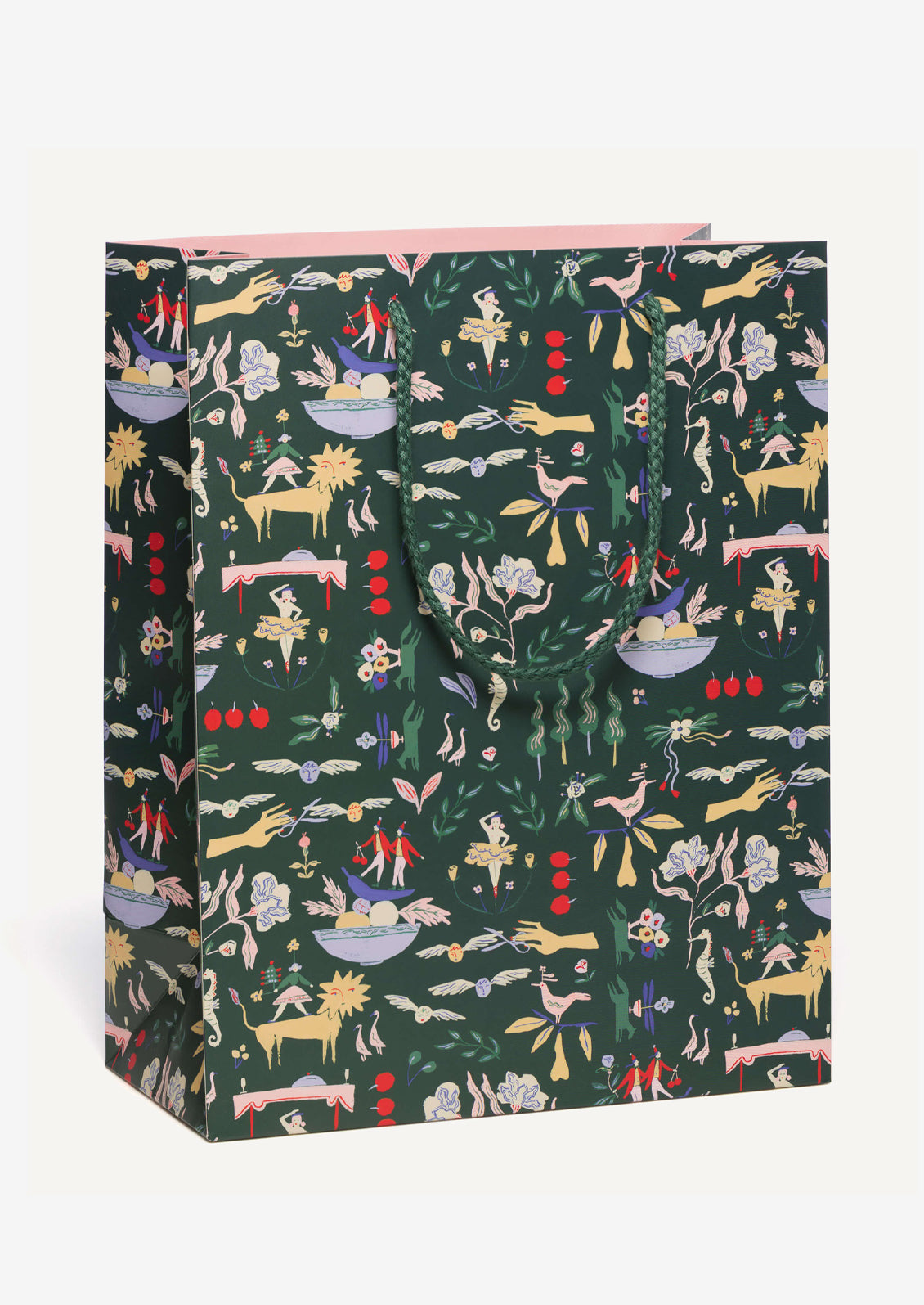 A large printed gift bag in dark green with whimsical, Nutcracker themed holiday print.