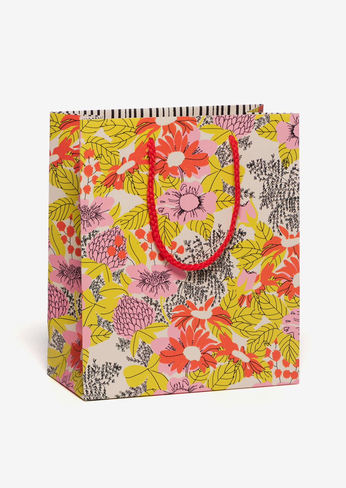 A printed gift bag with yellow, red and pink floral print.