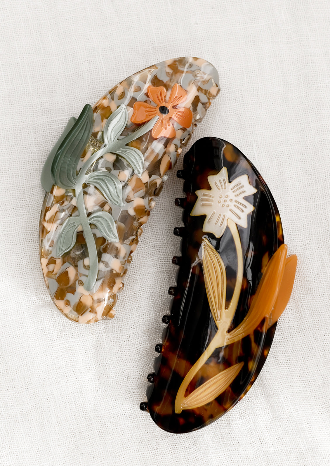 Large acetate hair claws with floral patterns.