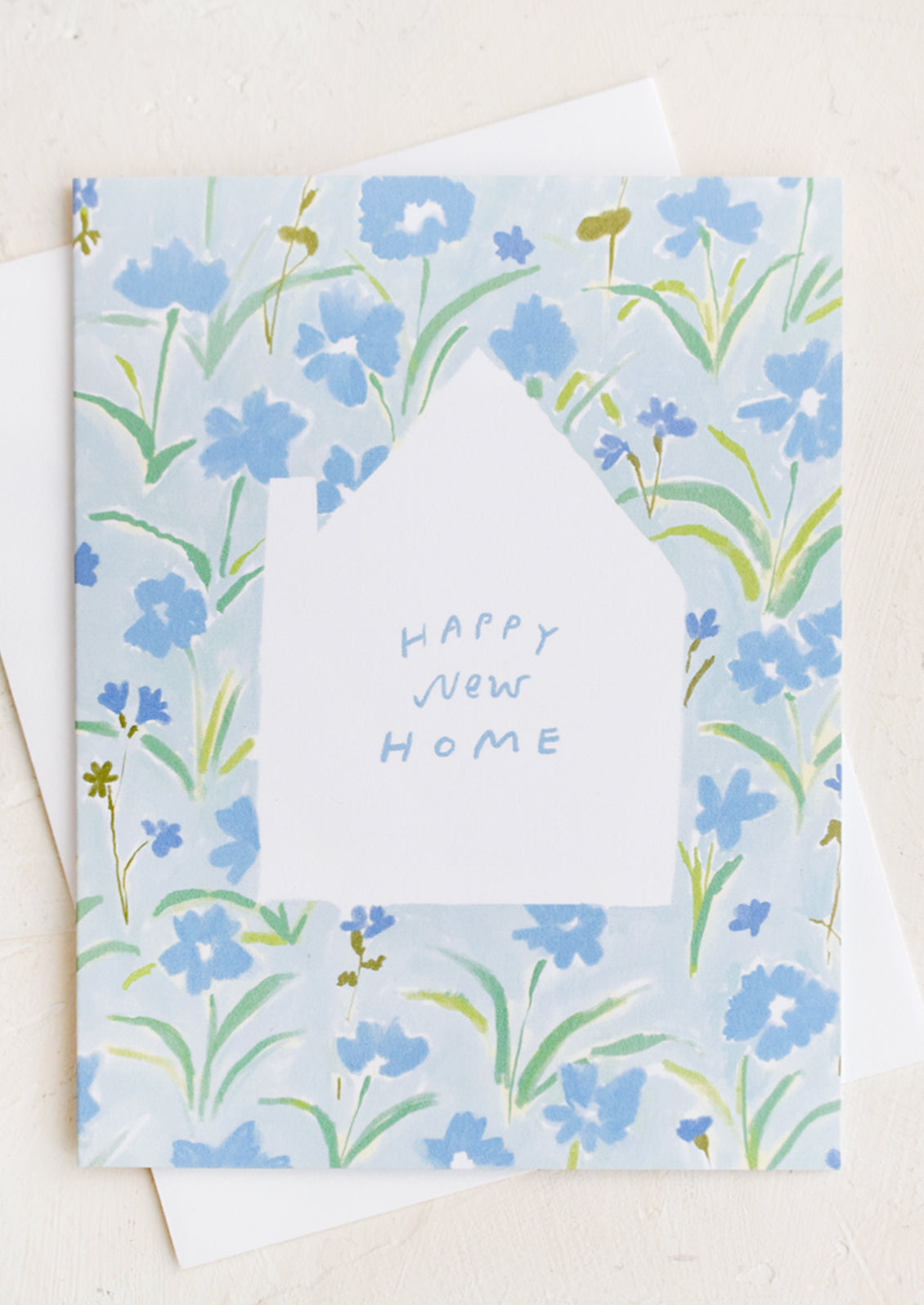 A greeting card with house cutout and floral pattern.