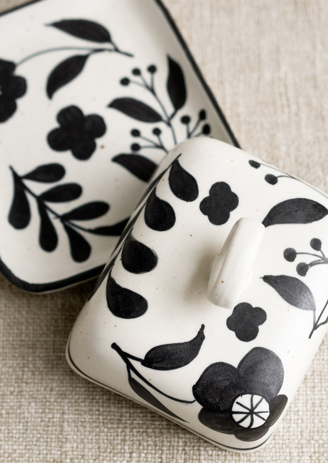 A black and white floral print butter dish.