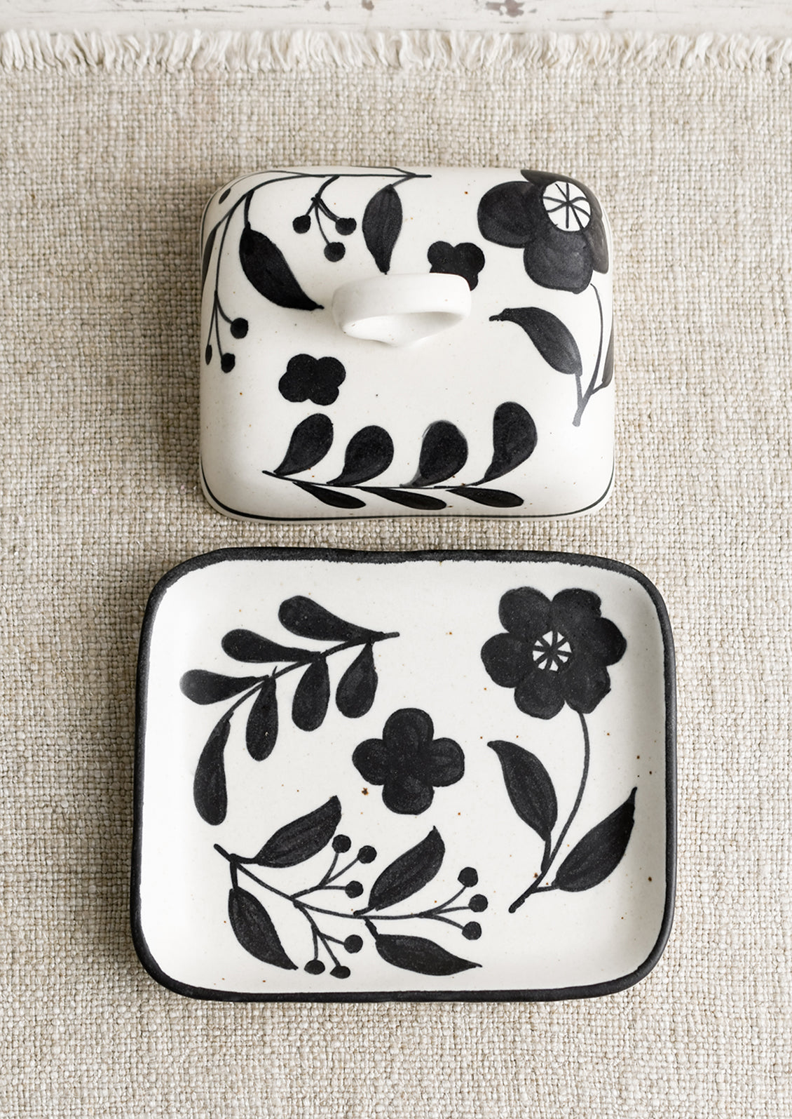 A black and white floral print butter dish.