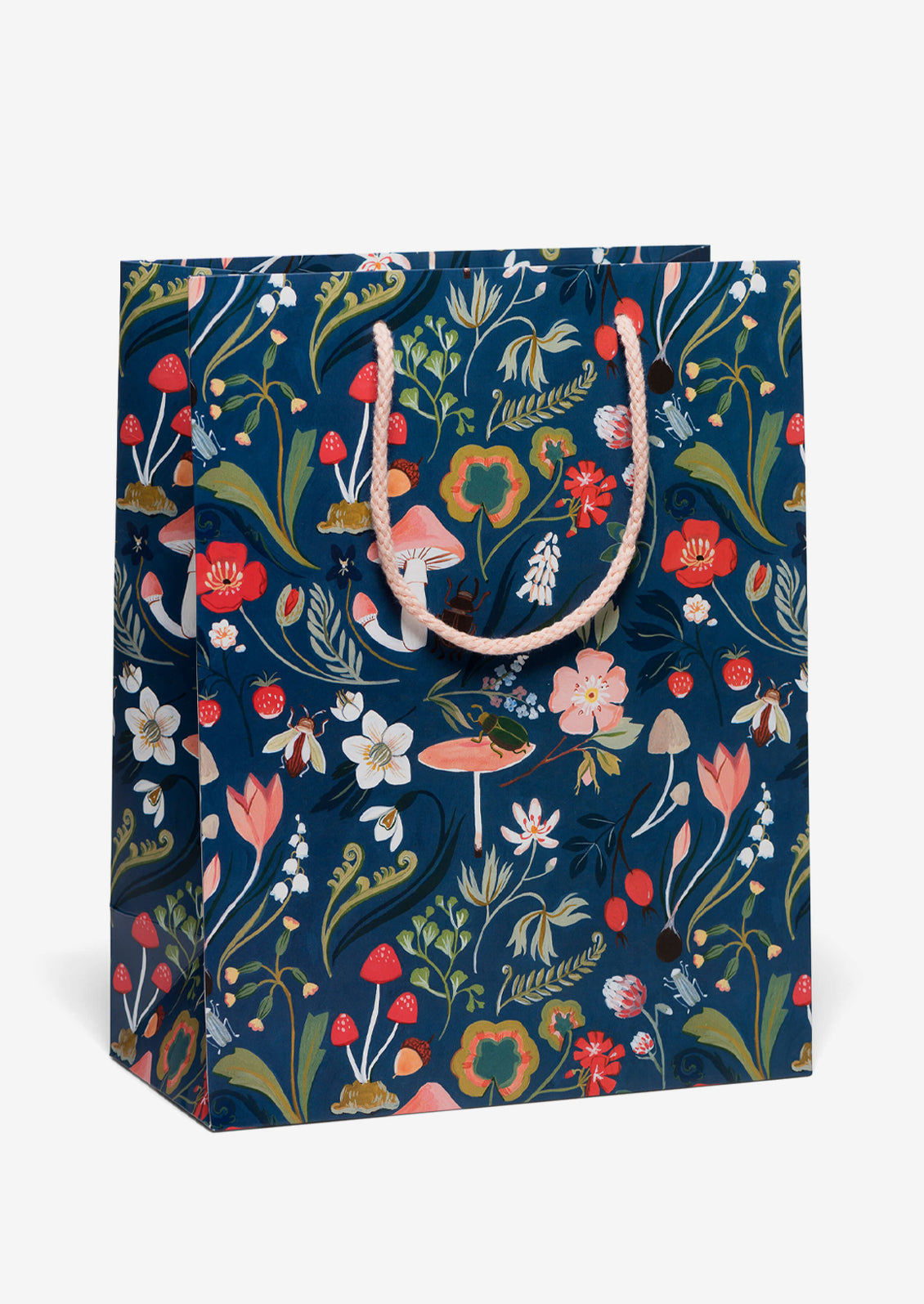 A printed gift bag with mushroom and plant print on navy blue background.