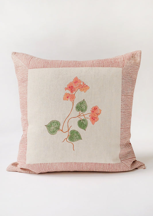 A block printed linen pillow in natural with pink bougainvillea print.