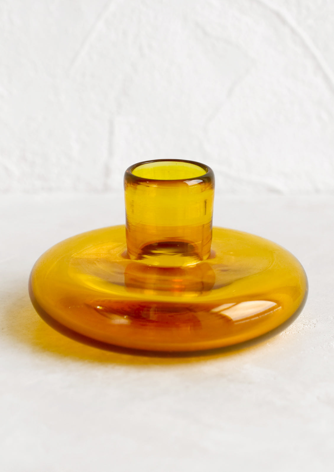 A glass taper candle holder in honeycomb.