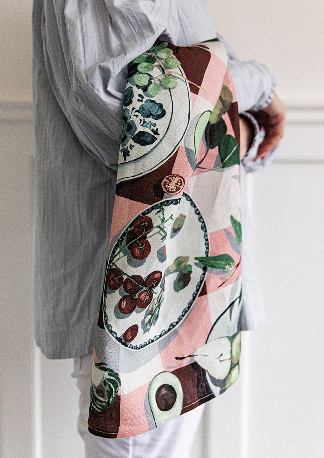 A printed linen tea towel with gingham fruit print.