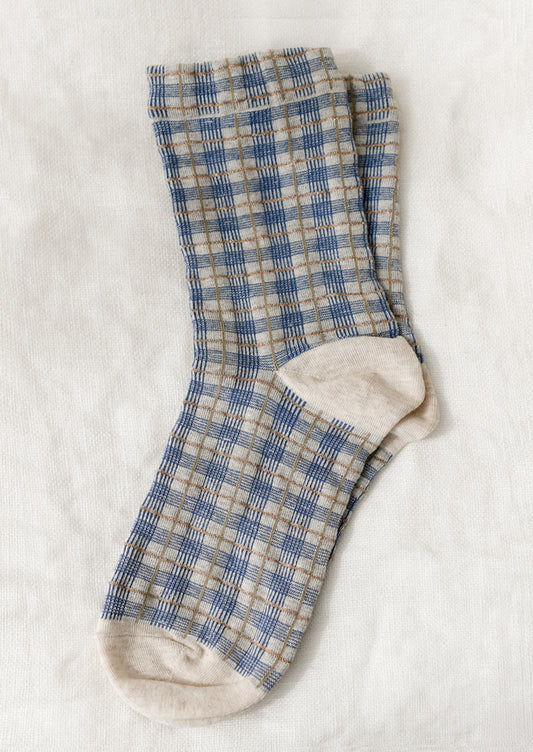 A pair of socks with blue and gold plaid pattern.