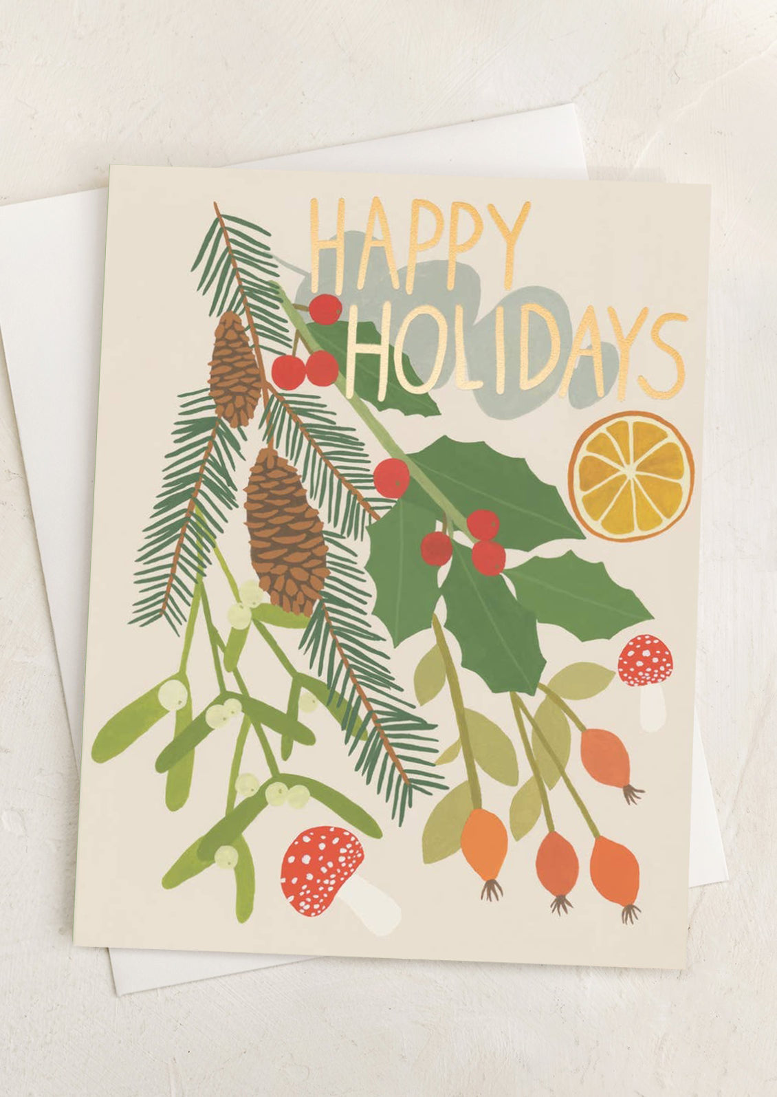 A card with illustration of pinecones, holly, berries, mushrooms, etc., text reads "happy Holidays.