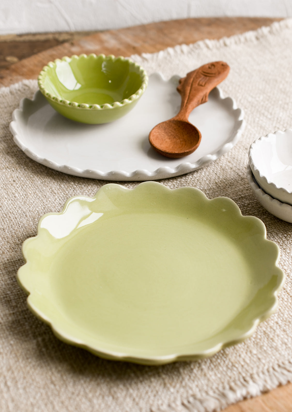 A tableware scene of assorted ceramics in green and white.