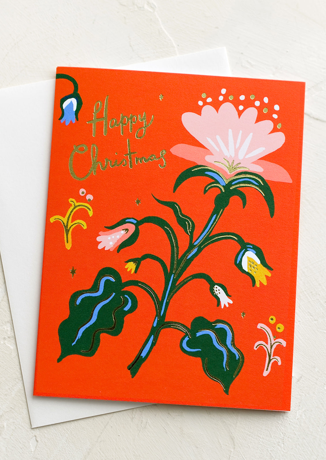 A red greeting card with flower, text reads "Happy Christmas".