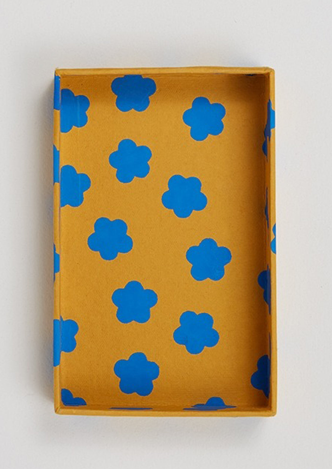 A set of cards in orange and blue flower print box.