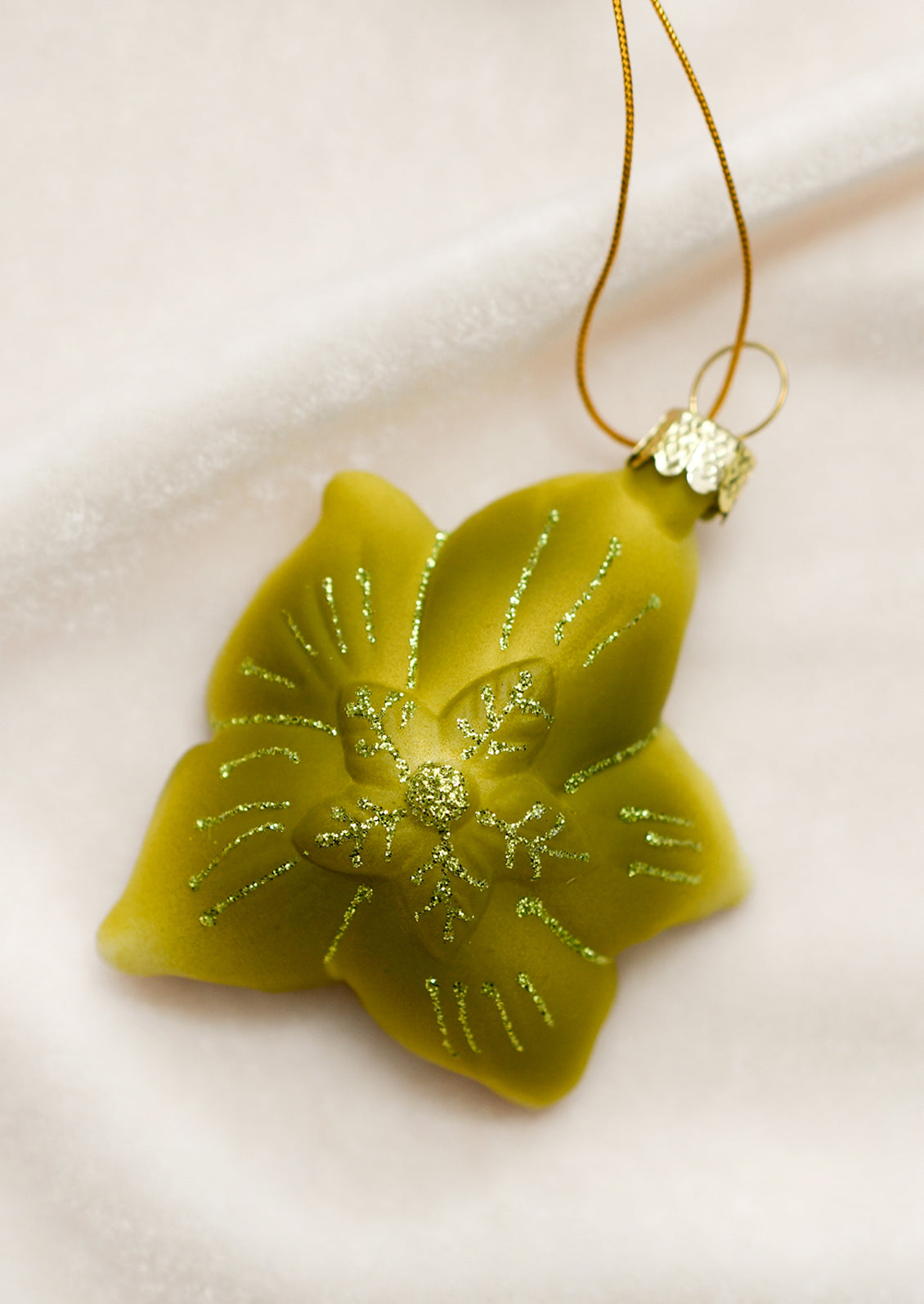 A glass ornament depicting a hellebore flower.