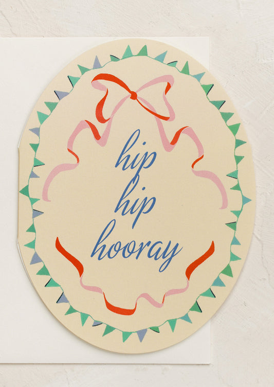 An oval shaped card with ribbon illustration, text reads "Hip hip hooray".