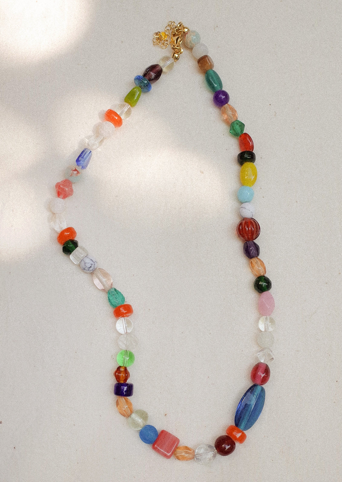 A beaded necklace with wide range of bead types, has a chunky look.