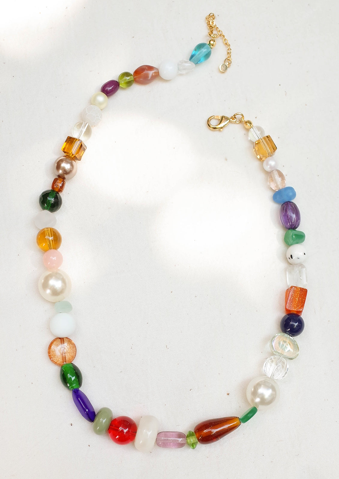 A beaded necklace with wide range of bead types, has a chunky look.