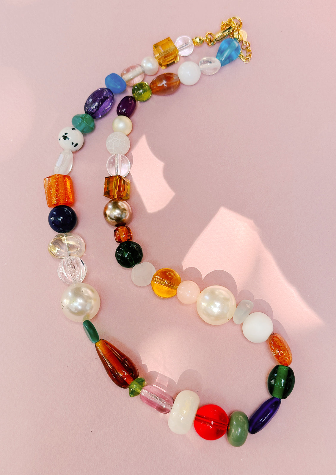 A beaded necklace with wide range of bead types, has a chunky look.