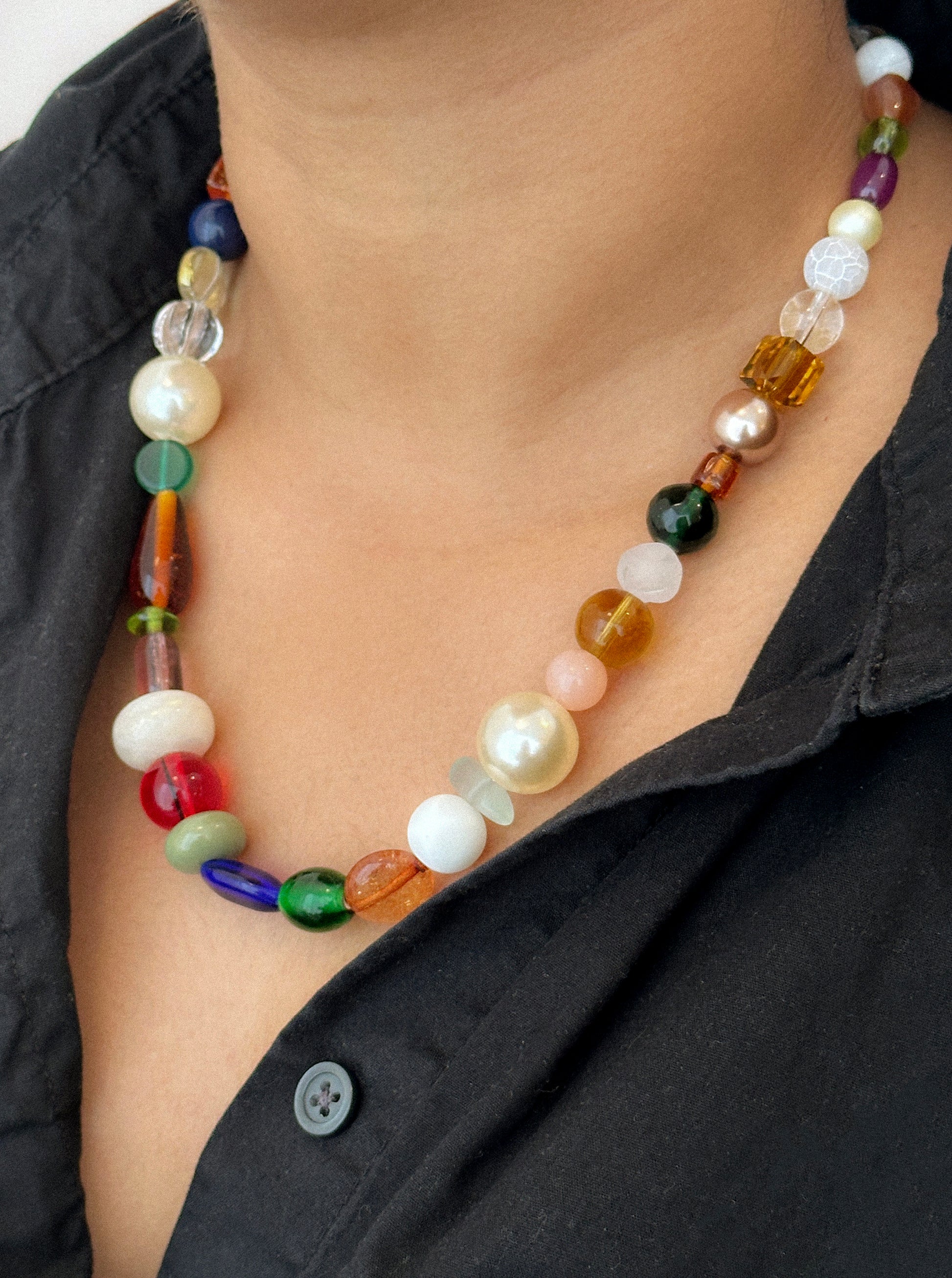 A beaded necklace with wide range of bead types, has a chunky look.