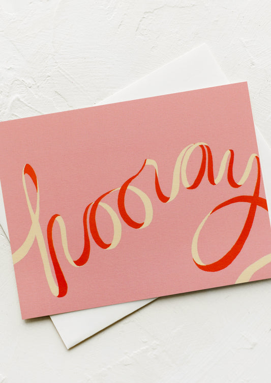 A card with ribbon-like font reading "Hooray".