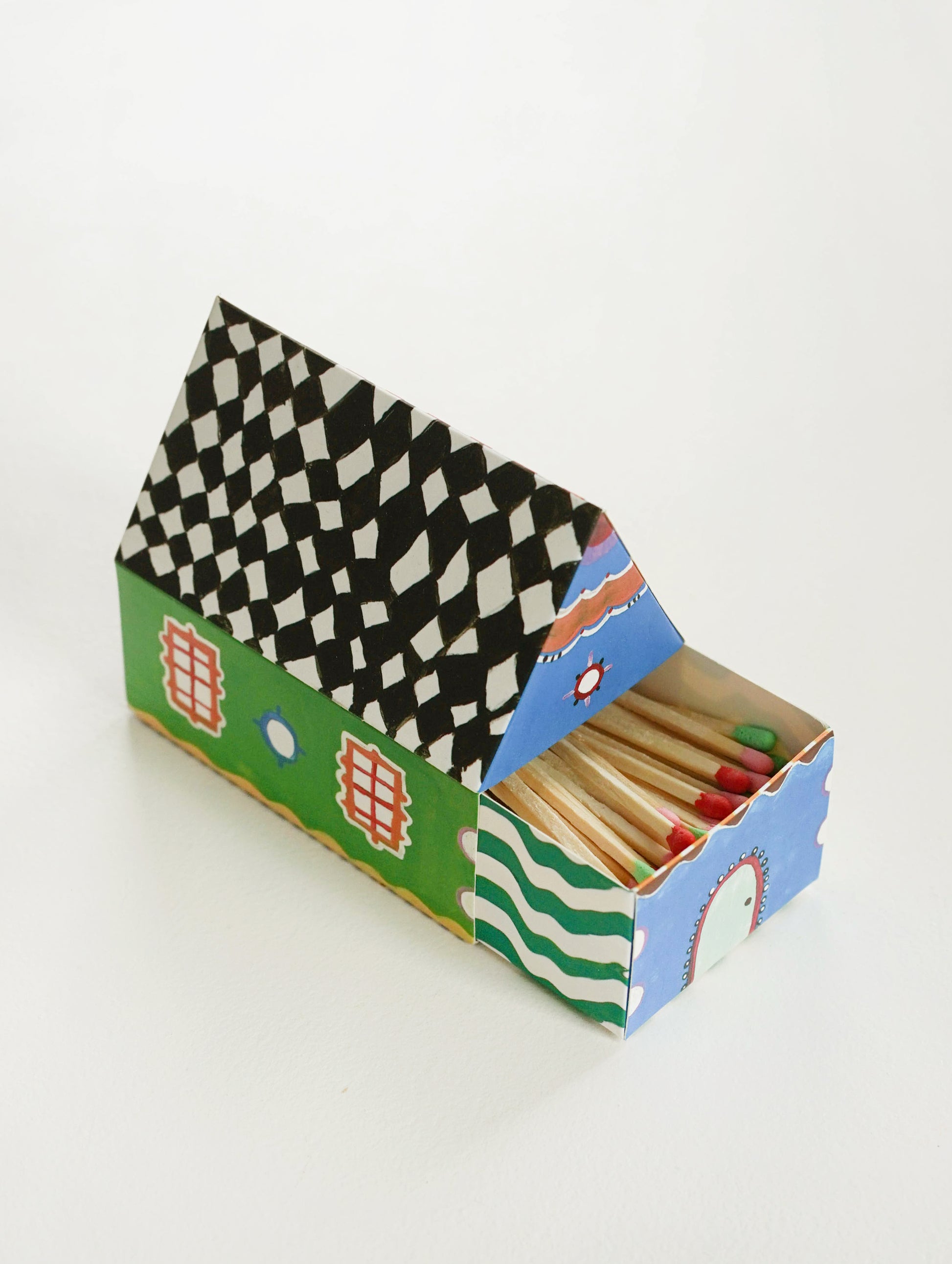 Two sides of a box of matches shaped like a house.