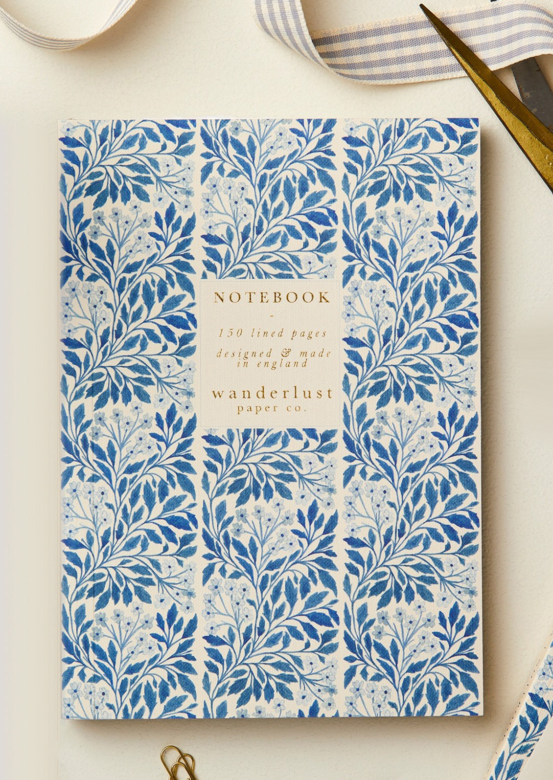 A blue and white floral print notebook.