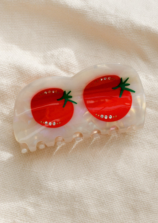 A pearlescent hair claw with tomato with crystal detailing.