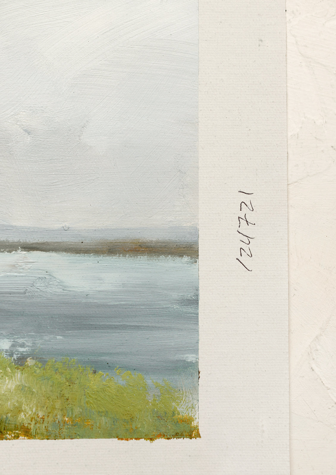 An original oil painting on unstretched canvas of a lake viewed from land.