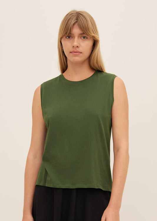 A person wearing a sleeveless muscle tank in forest green.