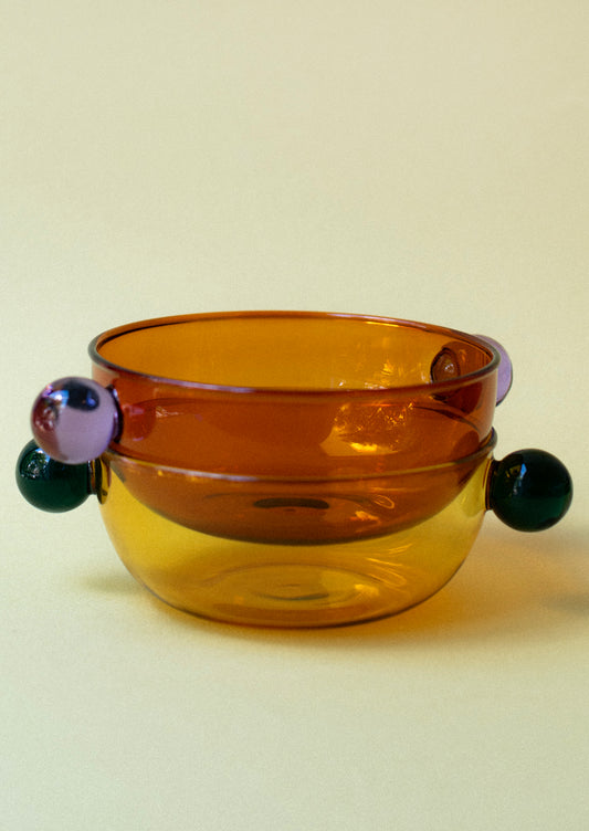 Glass bowls in translucent glass, shown in different colors.