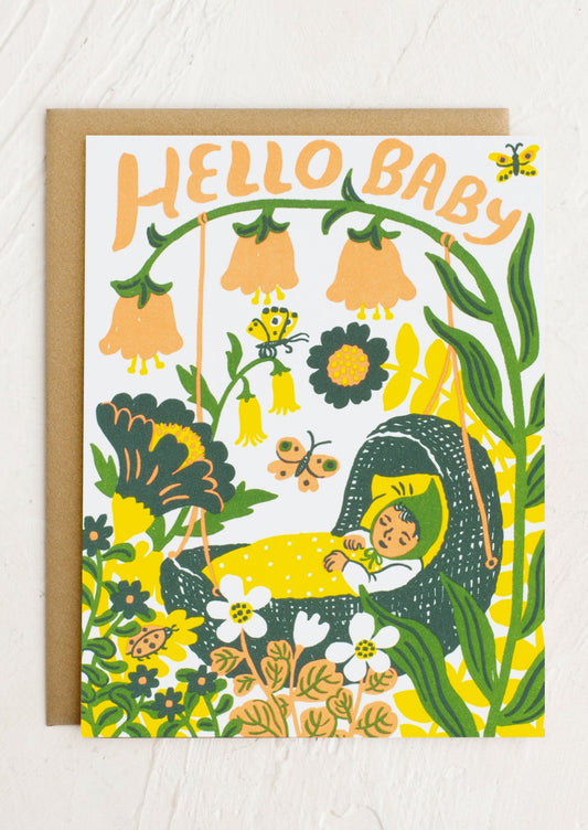 A card with image of baby in bassinet among forest, text reads "Hello baby".