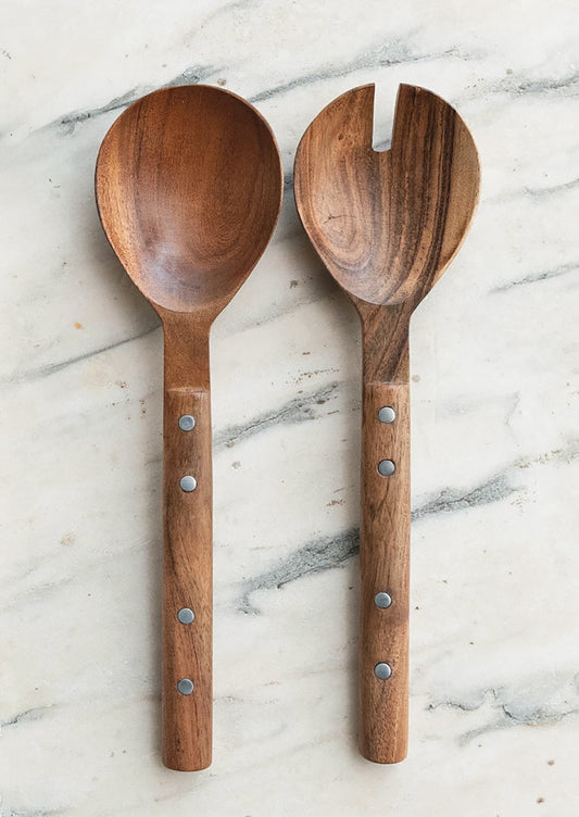 A pair of mango wood serving spoons with silver stud detail on handles.