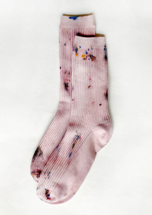 A pair of tie dye socks in dusty pink color.