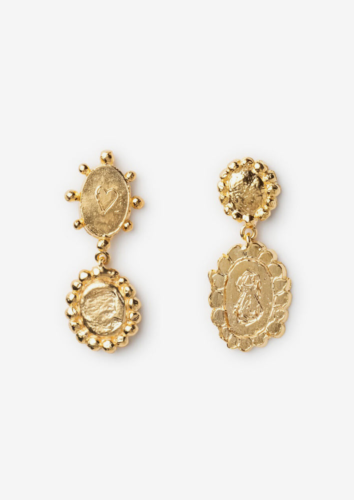 A pair of gold earrings in mismatched, ornate and baroque inspired design with etching.