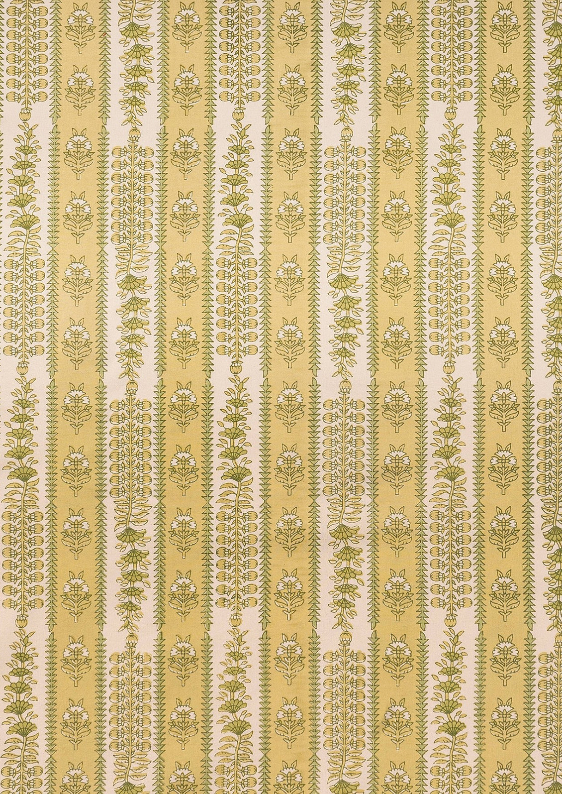 A block printed botanical patterned tablecloth in pastel yellow and green tones.