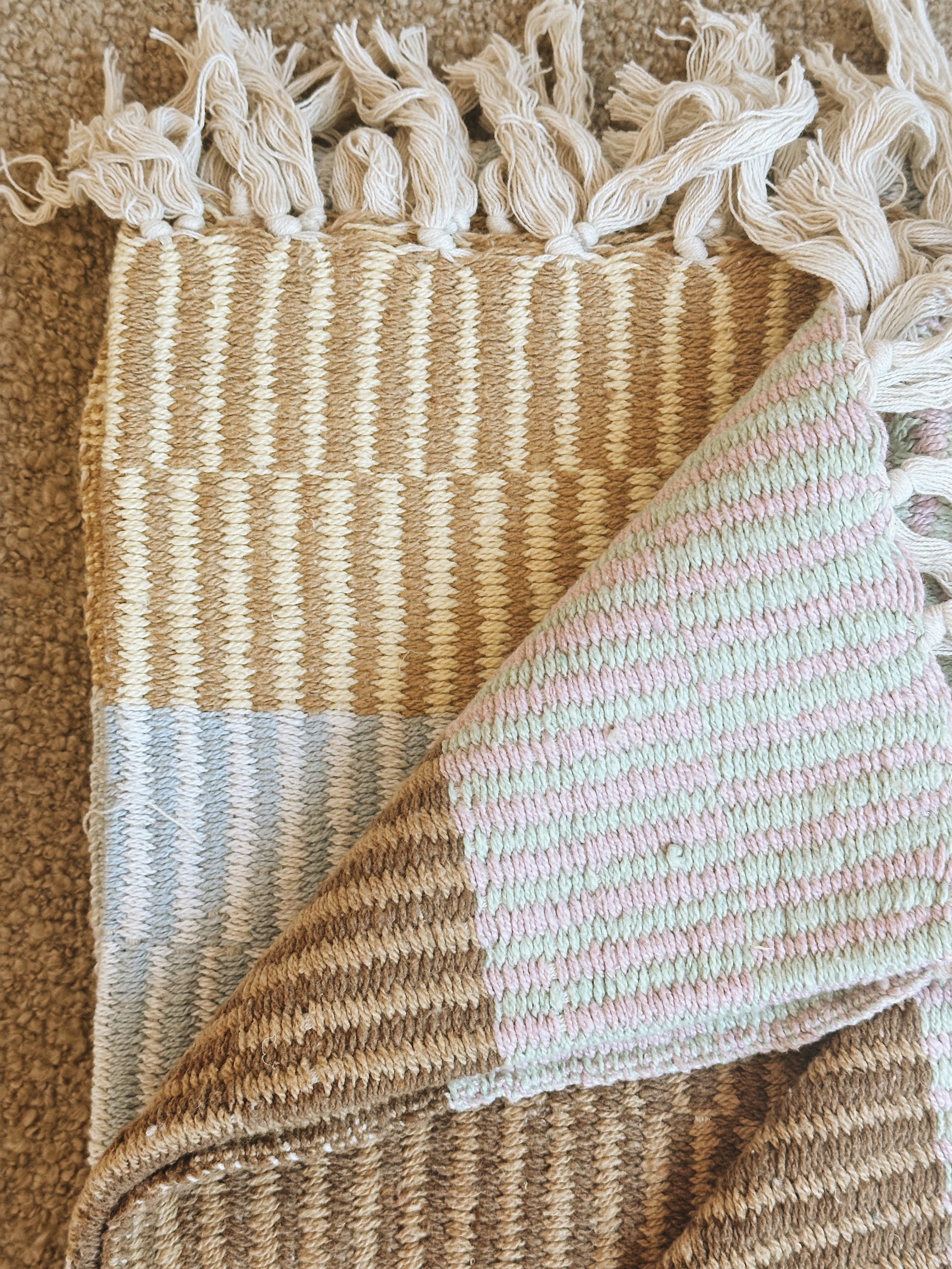 A striped throw blanket in pastel tones.