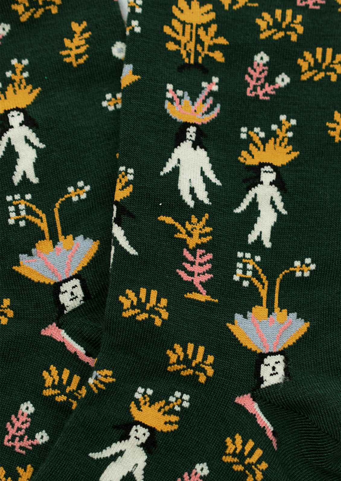 A pair of dark green socks with whimsical woman and flower print.