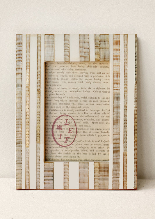 A picture frame in cream with carved textured beige vertical stripes.