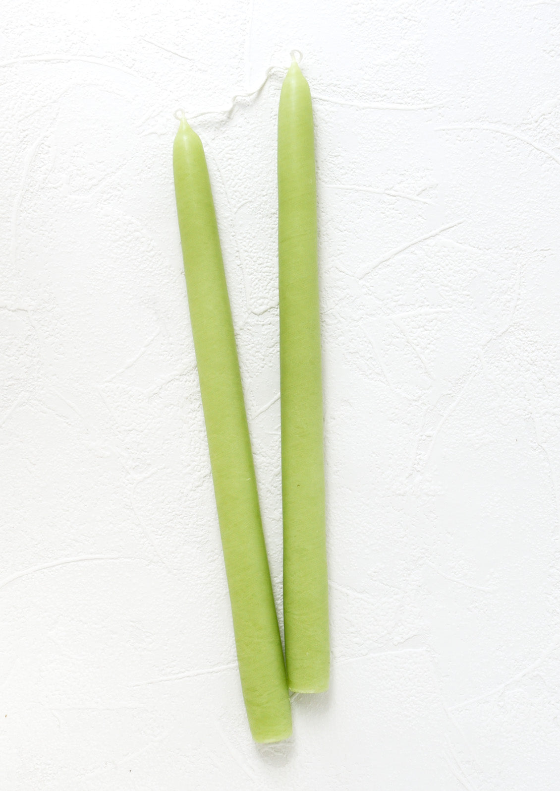 A pair of taper candles in lime.