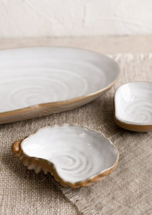 Ceramic serving dishes that look like shells.