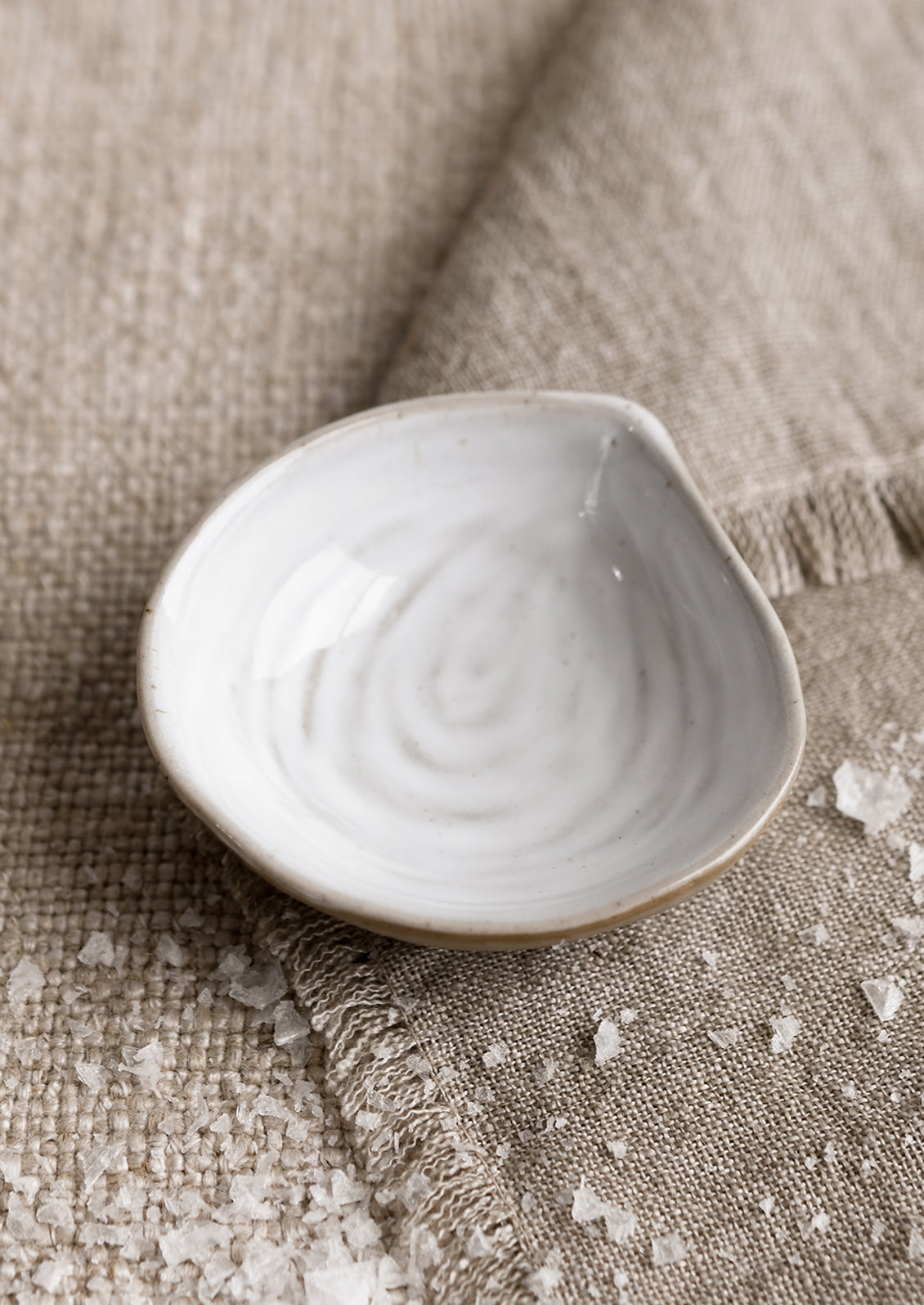 A small ceramic serving dish in shape of a mussel shell.