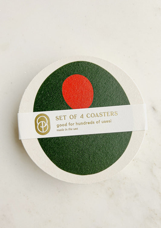 A set of paper coasters in pimento olive print.