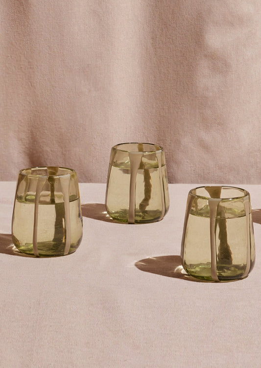 Glass tumblers in olive tinted clear glass with opaque vertical stripes.