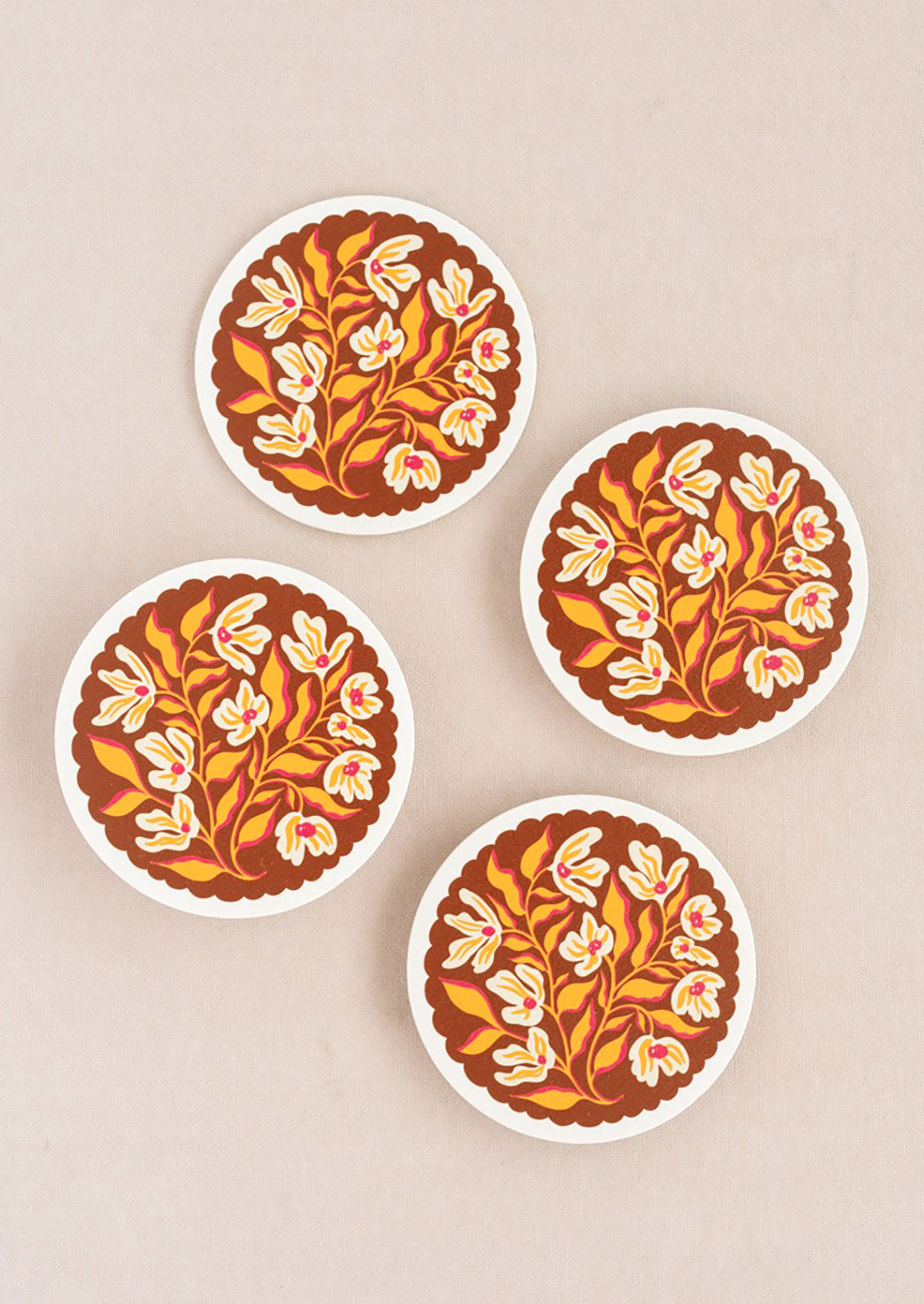 A set of scalloped amber floral coasters.