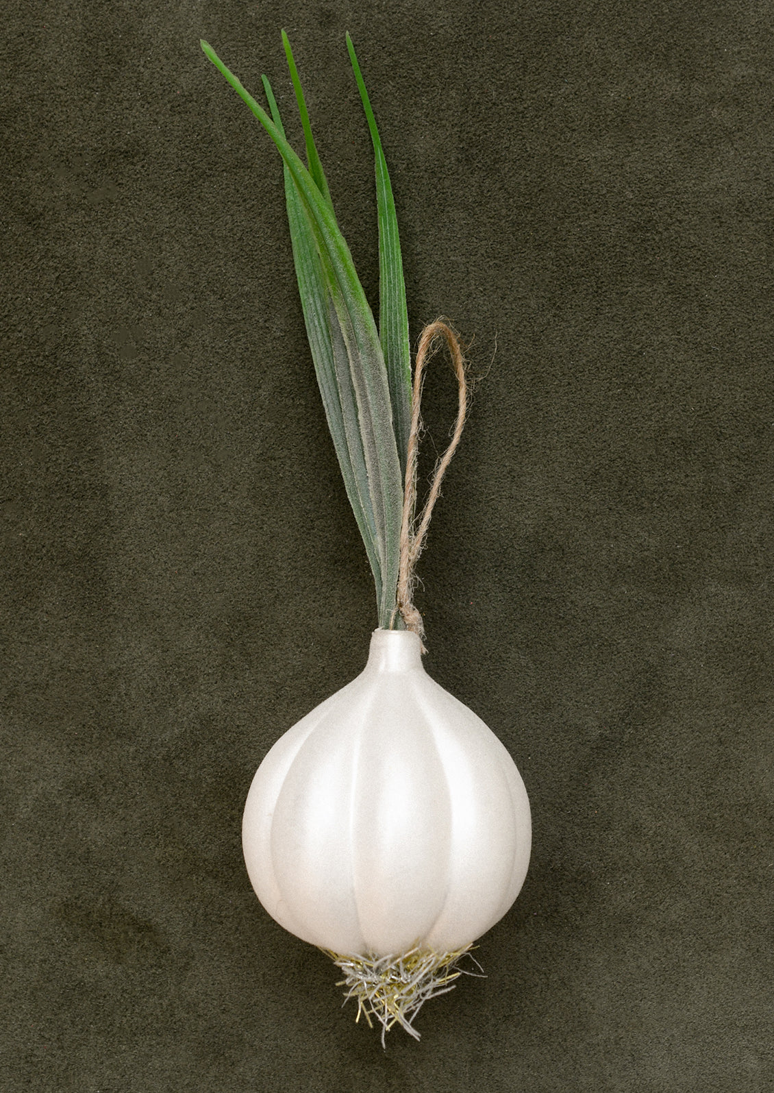 A glass ornament resembling a large white onion with stalk.