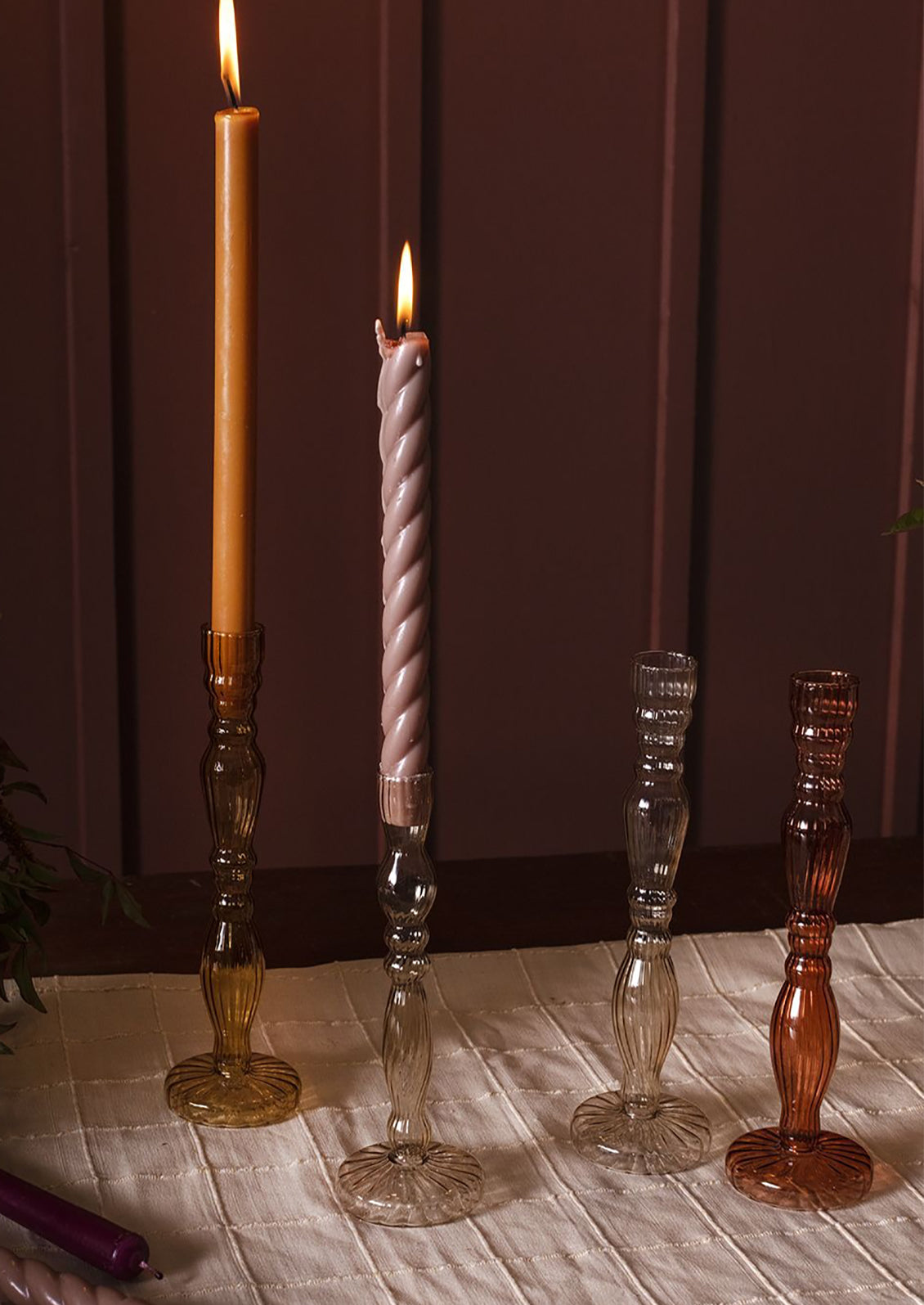 Assorted colors of optic glass candleholders with taper candles.