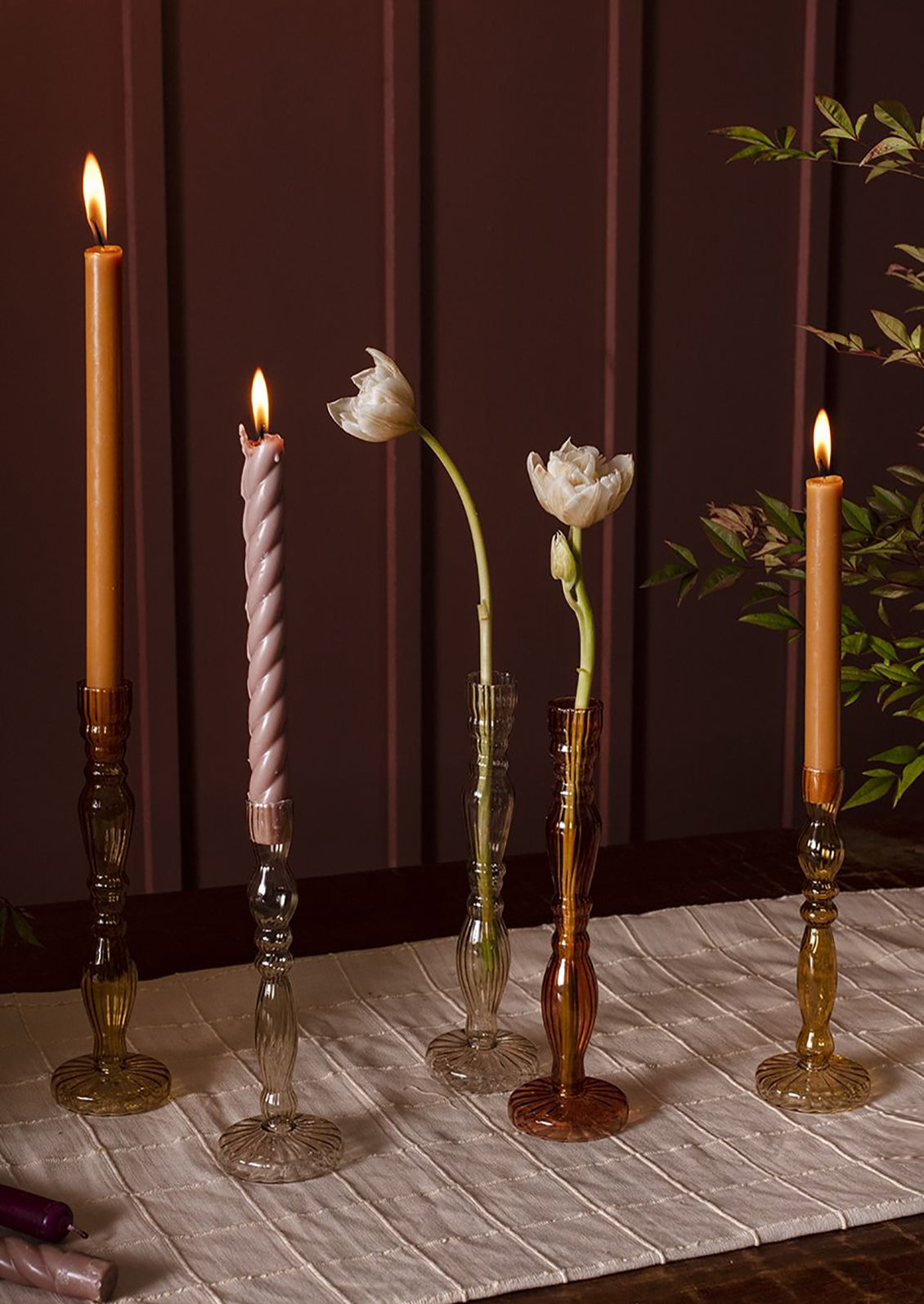 Assorted colors of optic glass candleholders with taper candles.