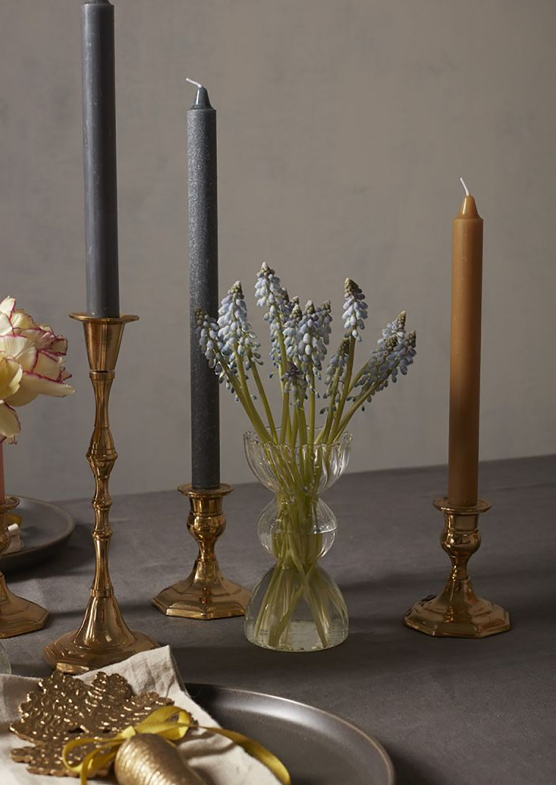 A glass vase with flowers on a table.