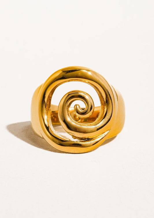 A swirl shaped ring in gold.