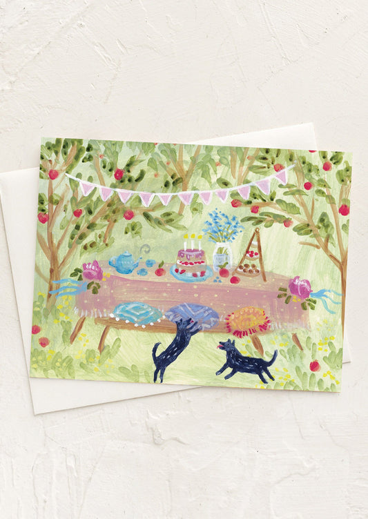 A card with illustration of black dogs at an outdoor garden party.