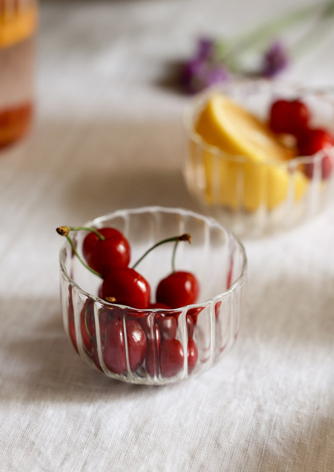 A small clear glass bowl with fluted texture.