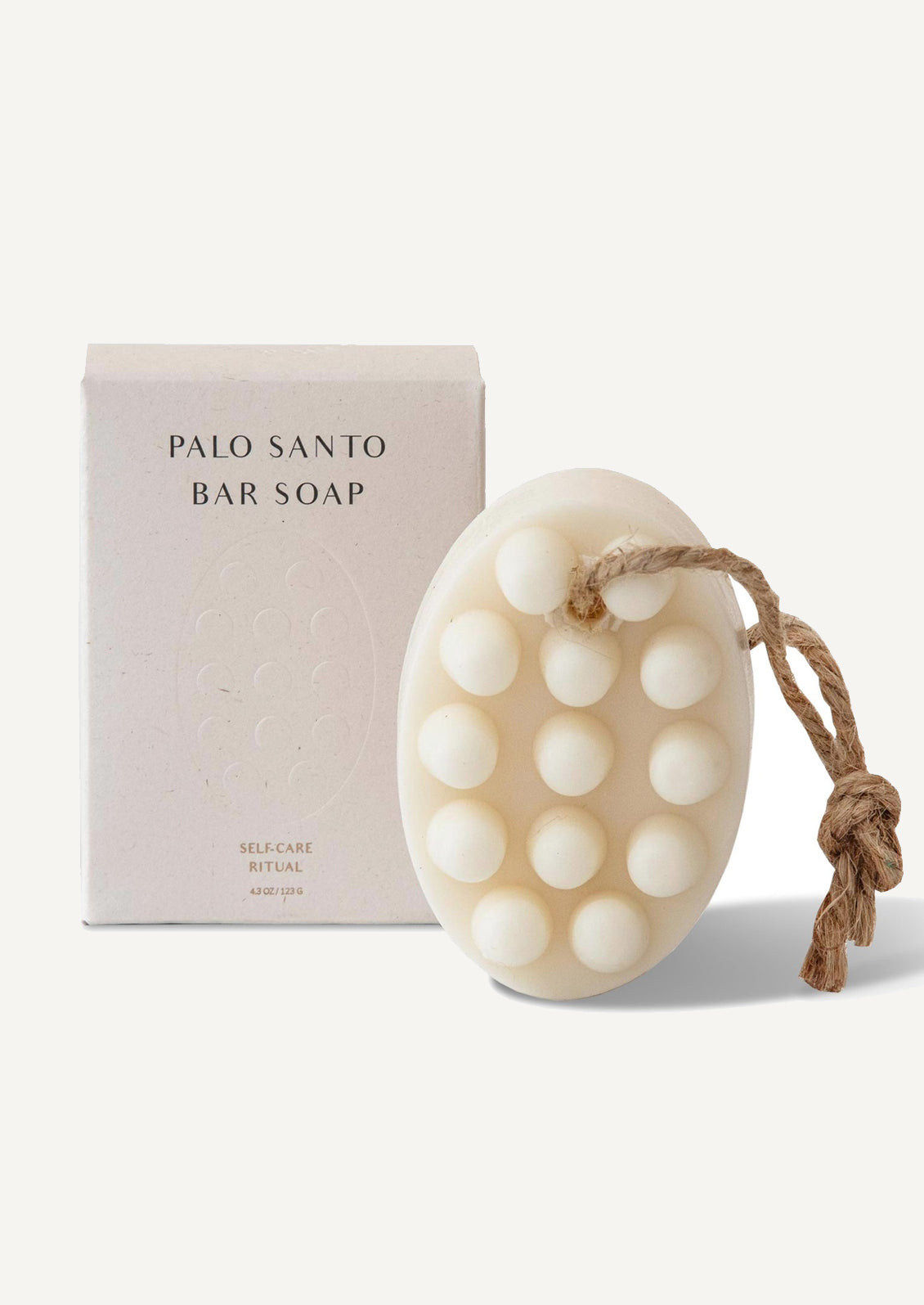 A massager style soap bar with hanging rope, comes with boxed packaging.